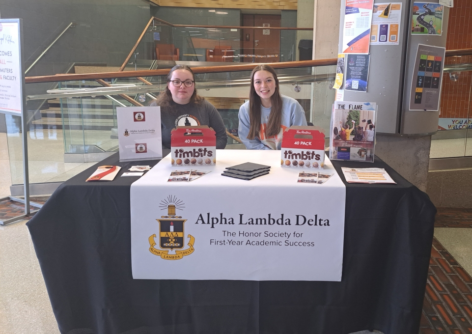 Two ALD members at a tabling event for Alpha Lambda Delta